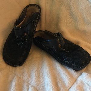 Alegria black slip on clogs.